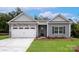 Charming single-story home with stone accents, gray siding, white garage door, and well-manicured lawn at 7121 Jerimoth Dr, Charlotte, NC 28215