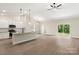Open-concept kitchen features white cabinets, granite countertops, stainless steel appliances, and hardwood floors at 7121 Jerimoth Dr, Charlotte, NC 28215