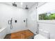 Modern bathroom showcases a frameless glass shower with dual shower heads and teak wood flooring at 7123 Linda Lake Dr, Charlotte, NC 28215