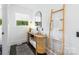 Bright bathroom features a stylish vanity, arched mirror, and a decorative wooden towel ladder at 7123 Linda Lake Dr, Charlotte, NC 28215