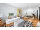 Stylish bedroom with white brick, bright walls, hardwood floors, and a comfortable daybed at 7123 Linda Lake Dr, Charlotte, NC 28215