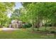 Exterior view of the home showcasing lush landscaping and a spacious driveway at 7123 Linda Lake Dr, Charlotte, NC 28215