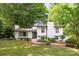 Charming white-brick home with well-manicured lawn and mature trees, offering great curb appeal at 7123 Linda Lake Dr, Charlotte, NC 28215