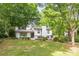 Inviting two-story home featuring a brick exterior, lush lawn, and mature shade trees at 7123 Linda Lake Dr, Charlotte, NC 28215