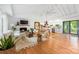 Open-concept living room featuring a fireplace, wood floors, and seamless access to the kitchen and dining areas at 7123 Linda Lake Dr, Charlotte, NC 28215