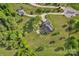 Aerial view of a home with lush landscaping, detached garage, and winding driveway at 814 Settlers Dr, Cherryville, NC 28021
