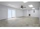 Spacious basement area with a ceiling fan, sliding glass door, and neutral paint throughout at 814 Settlers Dr, Cherryville, NC 28021