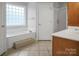 Main bathroom with a soaking tub, glass block window, and walk-in shower at 814 Settlers Dr, Cherryville, NC 28021