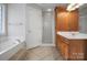 Main bathroom with a soaking tub, walk-in shower, and wood cabinets at 814 Settlers Dr, Cherryville, NC 28021