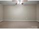 Neutral bedroom featuring a ceiling fan, carpet, and trim details for a cozy and inviting space at 814 Settlers Dr, Cherryville, NC 28021