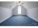 Large bonus room with carpet, neutral paint, ceiling fan, and a arched window for ample natural light at 814 Settlers Dr, Cherryville, NC 28021