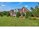 Charming brick home showcasing a lush front lawn and elegant landscaping, offering a welcoming curb appeal at 814 Settlers Dr, Cherryville, NC 28021