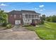 Backyard view of brick house with screened porch, patio, and landscaped yard, ideal for outdoor living at 814 Settlers Dr, Cherryville, NC 28021