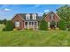 Beautiful brick home with manicured landscaping and inviting front porch at 814 Settlers Dr, Cherryville, NC 28021
