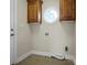 Laundry room with tile floors, storage, and a small round window for natural light at 814 Settlers Dr, Cherryville, NC 28021