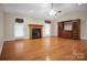 Inviting living room with hardwood floors, a fireplace, and built-in entertainment center at 814 Settlers Dr, Cherryville, NC 28021