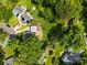 Aerial view of a home showcasing landscaping, mature trees, solar panels and a fenced in backyard at 917 Dent Ct, Charlotte, NC 28210