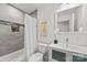 Bright bathroom featuring a tub with tiled walls, a vanity, and modern fixtures at 917 Dent Ct, Charlotte, NC 28210
