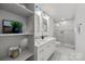 Modern bathroom featuring a double sink vanity, sleek fixtures, and a glass-enclosed shower at 917 Dent Ct, Charlotte, NC 28210