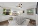 Cozy bedroom featuring a ceiling fan, windows providing natural light, and neutral decor at 917 Dent Ct, Charlotte, NC 28210
