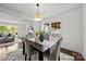 Bright dining room featuring modern lighting and decor adjacent to a cozy living room space at 917 Dent Ct, Charlotte, NC 28210