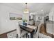 Elegant dining room with a stylish chandelier, hardwood floors and access to the kitchen at 917 Dent Ct, Charlotte, NC 28210