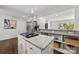 Spacious kitchen featuring a center island with gas cooktop, ample counter space, and modern decor at 917 Dent Ct, Charlotte, NC 28210