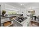 Open kitchen design featuring a gas cooktop island, sleek countertops, and seamless flow to the dining area at 917 Dent Ct, Charlotte, NC 28210