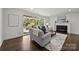Bright living room featuring large windows, hardwood floors and a cozy fireplace at 917 Dent Ct, Charlotte, NC 28210