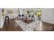 Well-lit living room with hardwood floors, contemporary furniture, and neutral decor at 917 Dent Ct, Charlotte, NC 28210