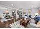Spacious living area that connects to dining and kitchen, featuring hardwood floors and open concept at 917 Dent Ct, Charlotte, NC 28210
