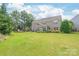 Wide view of a large backyard with a patio extending from the home at 9710 Holden Ct, Charlotte, NC 28277
