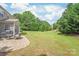A well-maintained backyard with a patio and lush green lawn with ample space for recreation at 9710 Holden Ct, Charlotte, NC 28277