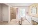 Bathroom featuring tiled walk-in shower, double sink vanity, and large window at 9710 Holden Ct, Charlotte, NC 28277