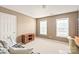 Bedroom features neutral carpet, a small desk, and two windows providing natural light at 9710 Holden Ct, Charlotte, NC 28277