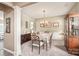 Traditional dining room with elegant chandelier, wood furniture, and neutral tones exudes classic charm at 9710 Holden Ct, Charlotte, NC 28277