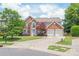 Beautiful brick home featuring a manicured lawn and two-car garage at 9710 Holden Ct, Charlotte, NC 28277