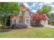 Charming brick home with blue shutters, a well-maintained lawn, and mature trees at 9710 Holden Ct, Charlotte, NC 28277
