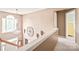 Hallway with large window, modern light fixture and views to the downstairs entryway at 9710 Holden Ct, Charlotte, NC 28277