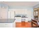 Functional kitchen with white cabinetry, granite countertops, and built in desk space at 9710 Holden Ct, Charlotte, NC 28277