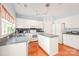 Bright kitchen with white cabinets, center island, and modern appliances provides ample space for cooking at 9710 Holden Ct, Charlotte, NC 28277