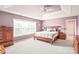 Spacious main bedroom features tray ceilings, ceiling fan, and large window offering ample natural light at 9710 Holden Ct, Charlotte, NC 28277