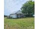 Quaint outbuilding on a grassy lot with a covered porch and various equipment, plus a large tree at Tbd Jerusalem Church Rd, Marshville, NC 28103