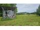 View of shed in the backyard with mature lawn, trees, and the main house in the distance at Tbd Jerusalem Church Rd, Marshville, NC 28103