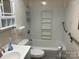 Neutral bathroom with tub and shower combo, white tiling, and grab bars for increased accessibility at 1014 Skyway Dr, Kannapolis, NC 28083