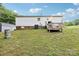 Back exterior showcasing a well-maintained yard, a small shed, and a private deck at 103 Palace Pt, Kings Mountain, NC 28086