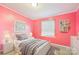 Cozy bedroom with a comfortable bed, soft lighting, and cheerful pink walls at 103 Palace Pt, Kings Mountain, NC 28086
