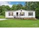 Charming single-story home with white siding, black shutters, and a lush green lawn at 103 Palace Pt, Kings Mountain, NC 28086
