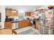 Functional kitchen with stainless steel appliances, wood cabinets, and a cozy dining area at 103 Palace Pt, Kings Mountain, NC 28086