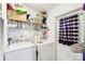 Practical laundry room with washer, dryer, and storage shelves for organization at 103 Palace Pt, Kings Mountain, NC 28086